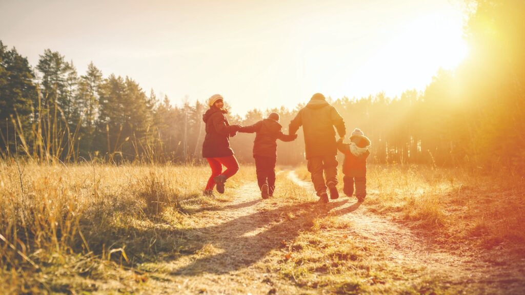 family running on country road in autumn time