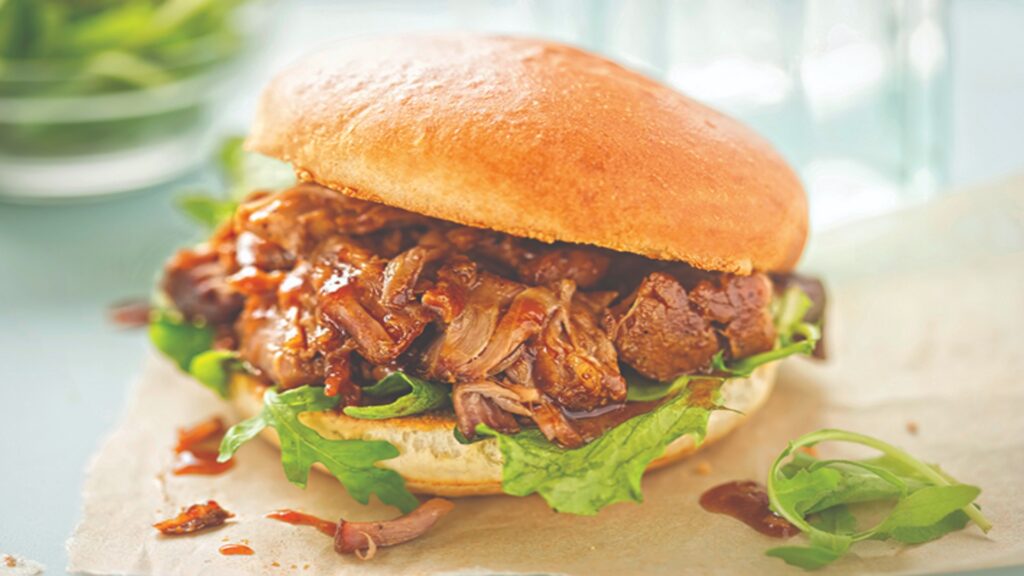 pulled pork sweet bun with mixed lettuce leaves