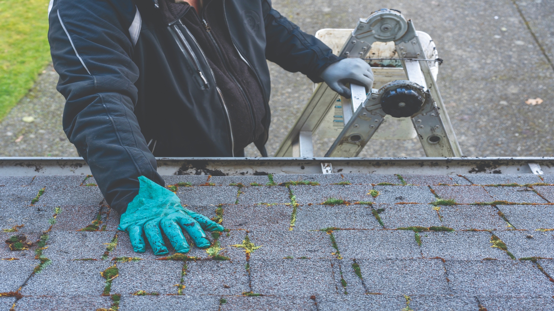 person cleaning roof