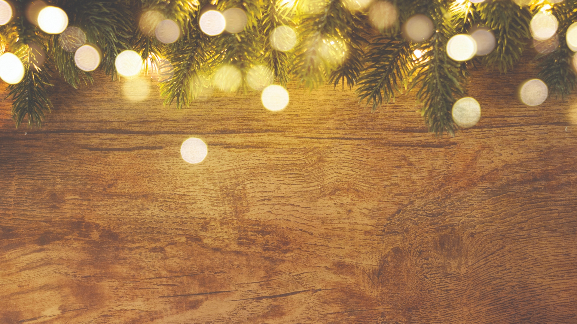 christmas and new year wooden background with light